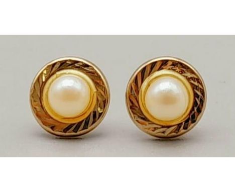 Two Pairs of 9K Yellow Gold Earrings. Seed pearl and Flower decoration. 1.15g total weight. 