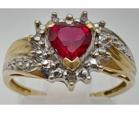 A 10K Yellow Gold Ruby Ring. Heart shaped ruby central stone surrounded by small white stones. Size N1/2. 2.49g 
