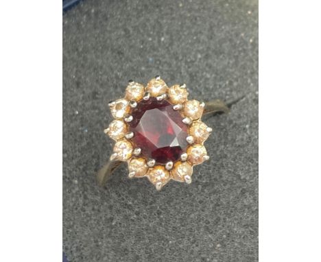 9 carat GOLD and oval Garnet ring having clear stone surround.2.3 grams approx. Size O - P. 