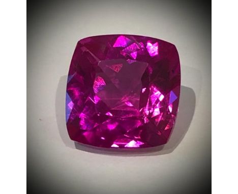 A Hypnotising 24ct Pink-Red Mogok Ruby. Cushion-cut with no visible marks or inclusions. 16 x 16 x 9mm. Mild heat treatment -