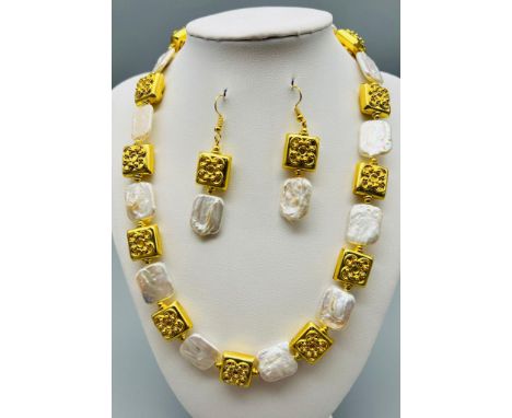 A highly unusual necklace with rectangular genuine, large pearls (20 x 15 mm) and 18 K yellow gold plated, ornate, spacer bea