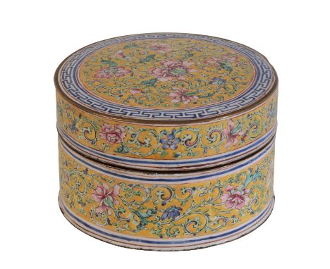 A CHINESE CANTON ENAMEL FAMILLE ROSE YELLOW-GROUND CIRCULAR BOX AND COVER painted with dense scrolling peonies and a blue key