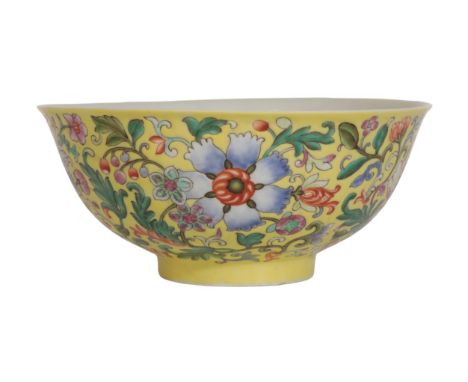 A CHINESE FAMILLE ROSE YELLOW-GROUND BOWL finely painted with flowers, the interior with five bats, the base with a four char