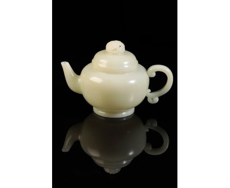 A FINE CHINESE WHITE JADE TEAPOT AND COVER of large size, the simple domed cover with a pierced finial intricately carved wit