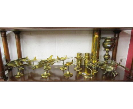 Shelf of brass aeroplanes etc