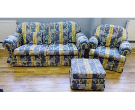 A four piece blue and cream upholstered floral pattern lounge suite comprising a three seater sofa, two easy chairs and a foo