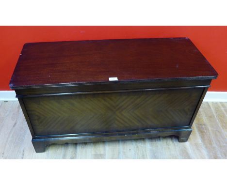 A reproduction mahogany blanket box with moulded top raised on bracket feet, 99 x 54cm