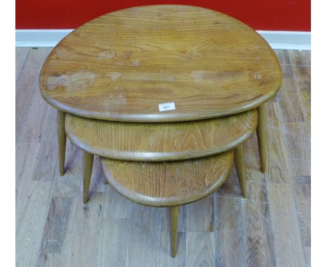 A nest of three Ercol pebble tables, 65 x 41cm
