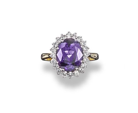 An amethyst and diamond cluster ring, the oval shaped amethyst is set within a surround of round brilliant cut diamonds in 18