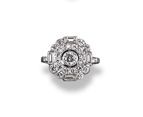 A diamond cluster ring, centred with a circular cut diamond within a surround of graduated circular cut diamonds and four bag