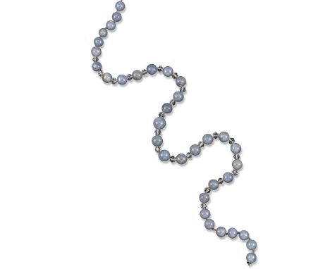 A jade bead necklace, the matched grey/lavender beads are each spaced with a crystal rondel. 59cm. Accompanied by report numb