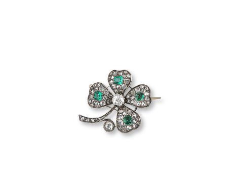 A late Victorian emerald and diamond four leaf clover brooch, each petal centred with an emerald within a surround of rose cu