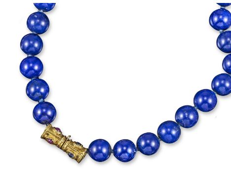 A single row lapis lazuli bead necklace, with cabochon sapphire and ruby set gold clasp. 45cm long.
