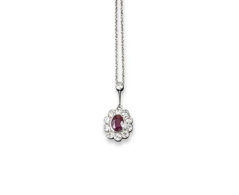 A ruby and diamond pendant, the oval-shaped ruby is set within a surround of circular cut diamonds in white gold and suspends
