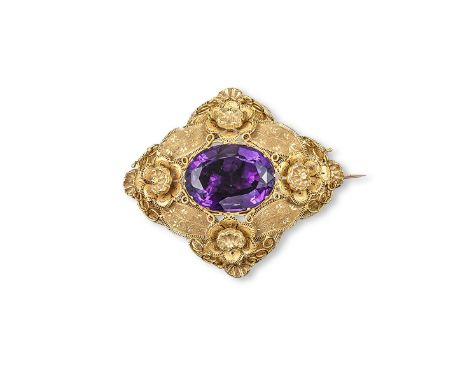 A 19th century gold brooch, set with a large oval shaped amethyst within gold filigree surround. 6cm wide. Fitted case.