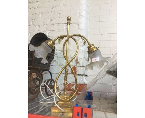 A brass lamp with pressed glass shades 