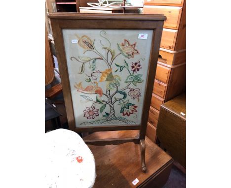 An embroidered fire screen. 