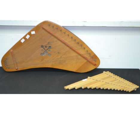 Musical Interest - an unusual shaped 15 string zither type musical instrument, lacking one string; a set of bamboo pipes (2)
