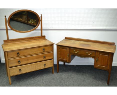 An early 20th century oak dressing table; an early 20th century mahogany desk, in the Chippendale Revival taste, c.1920 (2)