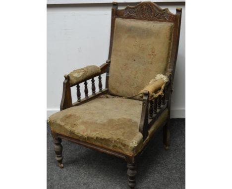 A Victorian salon armchair, caved top rail, padded back, spindled and padded arms, stuffed overseat, turned forelegs, ceramic