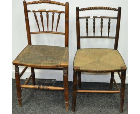 Two oak country chairs, bobbin turned top rail, turned tapering spindles to back, raffia seat, turned stretchers, circa 1860.