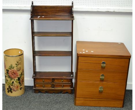 A teak wall shelf, pierced uprights, four shelves over four short drawers; a retro teak three drawer bedside cabinet; a stick