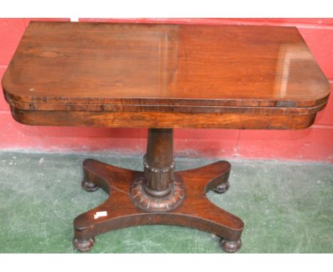 A William IV rounded rectangular rosewood card table, folding top enclosing a green baize-lined playing surface, lotus carved