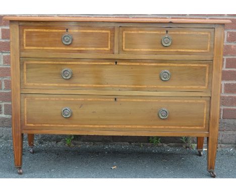 An Edwardian mahogany chest, crossbanded top, two short drawers over two graduated long, brass roundel escutcheons, tapering 