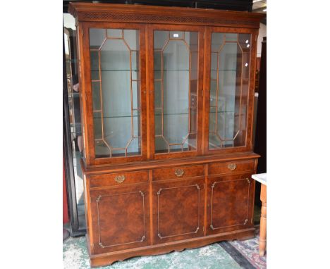 An Ian Smith Reproduction Furniture library bookcase, stepped cornice, blind fretworked frieze, three astragal glazed doors e