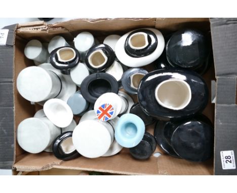 A collection of ceramic Winston Churchill themed ceramic top hats.
