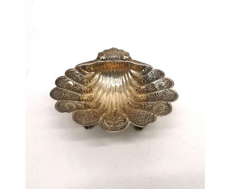 A vintage silver engraved clam shell form trinket dish by J B Chatterley &amp; Sons Ltd. Engraved with a stylised floral desi