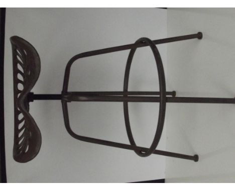Revolving stool fashioned from a tractor seat 