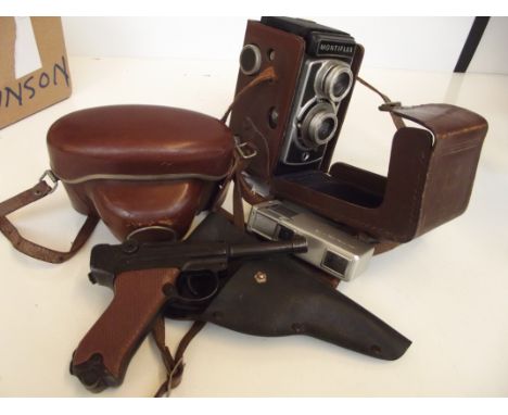 Two vintage cameras together with a spy camera, also a vintage Luger cap gun 