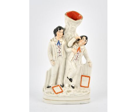 Sir Roger Moore  an antique (c. late 19th century) Staffordshire spill vase fashioned in the style of two young men standing 