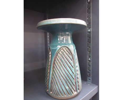 A Poole pottery vase of stylized design having incised turquoise glaze stamped JH A92