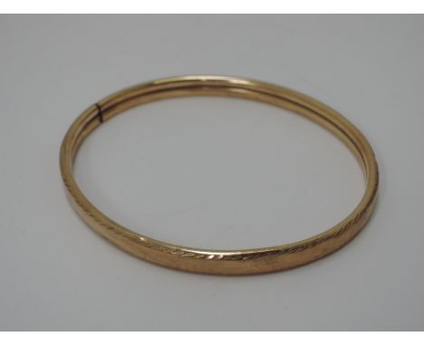A 9ct gold bangle of plain form