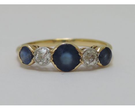 A ladies dress ring having three graduated sapphires interspersed by two diamonds in raised collared mount on a yellow metal 