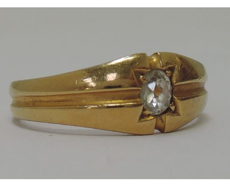 An 18ct gold signet ring having an oval diamond within a starburst setting