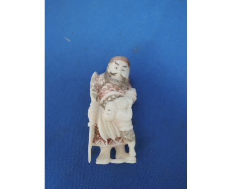 A 19th century Chinese ivory netsuke modelled as traveller and child