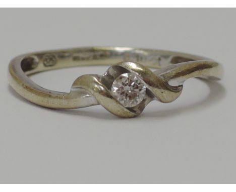 A ladies diamond solitaire ring in a twist mount on a 9ct white gold mount