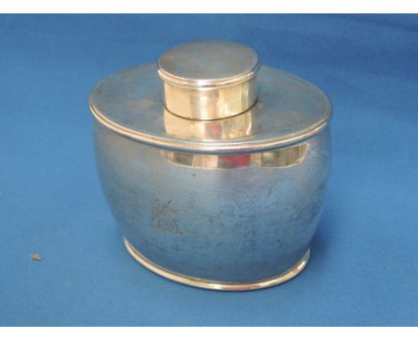 A Victorian oval silver tea caddy of plain form with lid,  having dog emblem to front, London 1887, John Aldwinkle & Thomas S
