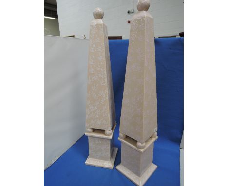 A pair of late 20th century ceramic table ornaments modelled as buff obelisks, retailed by Harrods