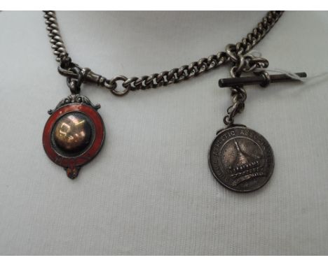 An HM silver watch chain with white metal fob re:  Burma Athletic Association and a white metal and red enamel medalion