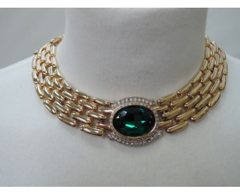 A 1980's collarette necklace having a central oval green paste stone with diamante surround