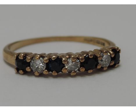 A diamond and sapphire half eternity ring on a 9ct gold band