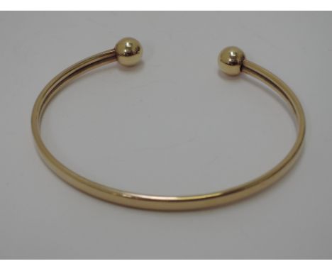A 9ct gold open bangle