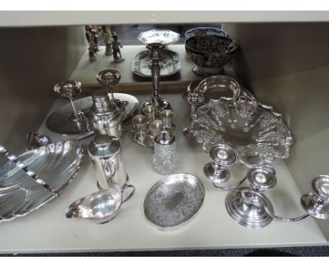 A selection of plated ware including cocktail shaker, baskets, candle stick, sugar dredger, ladle etc