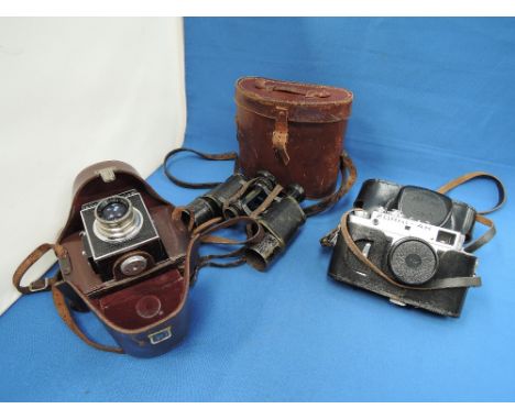 A pair of World War II military binoculars, O'Donohoe, Berlin, in case a Korelle Reflex camera and a Zorki 4K camera