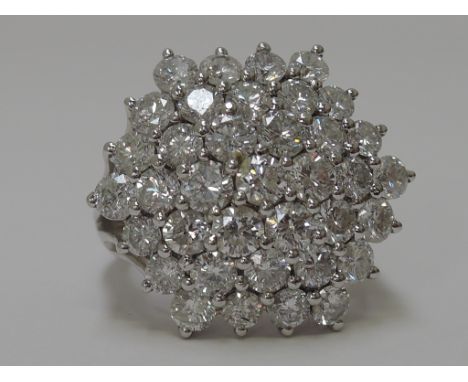 A ladies hexagonal shaped diamond cluster ring having 37 brilliant cut diamonds in claw setting (approx 5ct) on open shoulder