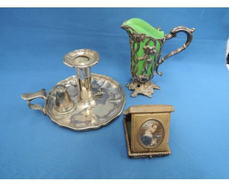 A silver plated chamber stick stamped 1194W, a Victorian jug having green glass liner and white metal foliate case, and an It